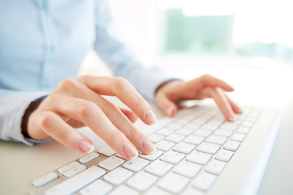 Person typing on a keyboard